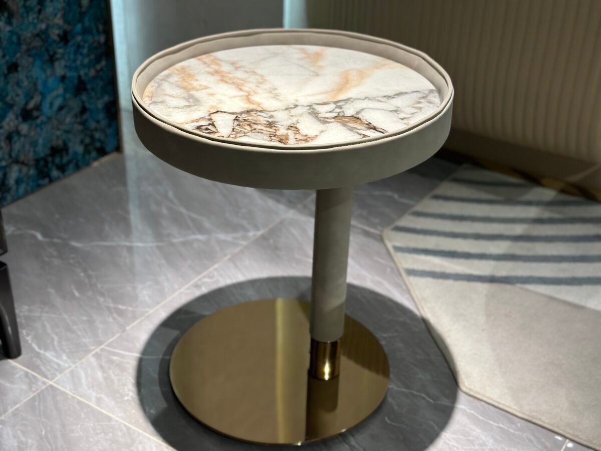 Contemporary marble side table brown copper finish styled in modern residential living room bedroom interior
