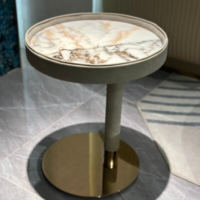 Contemporary marble side table brown copper finish styled in modern residential living room bedroom interior