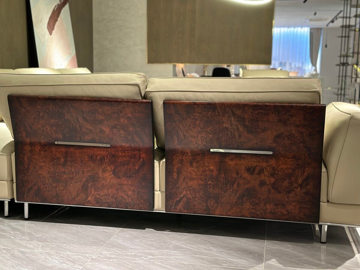 Close-up wood grain matte finish texture and genuine leather upholstery on corner sofa unit