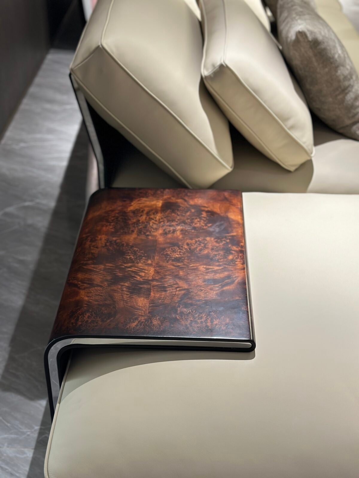 Close-up wood grain matte finish texture and genuine leather upholstery on corner sofa unit