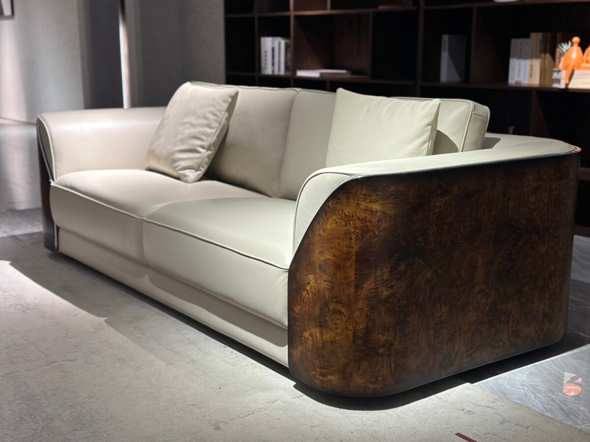 Close-up glossy burgundy genuine leather surface and wooden leg construction detail