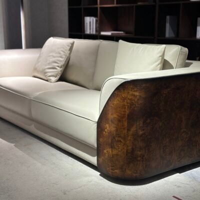 Close-up glossy burgundy genuine leather surface and wooden leg construction detail