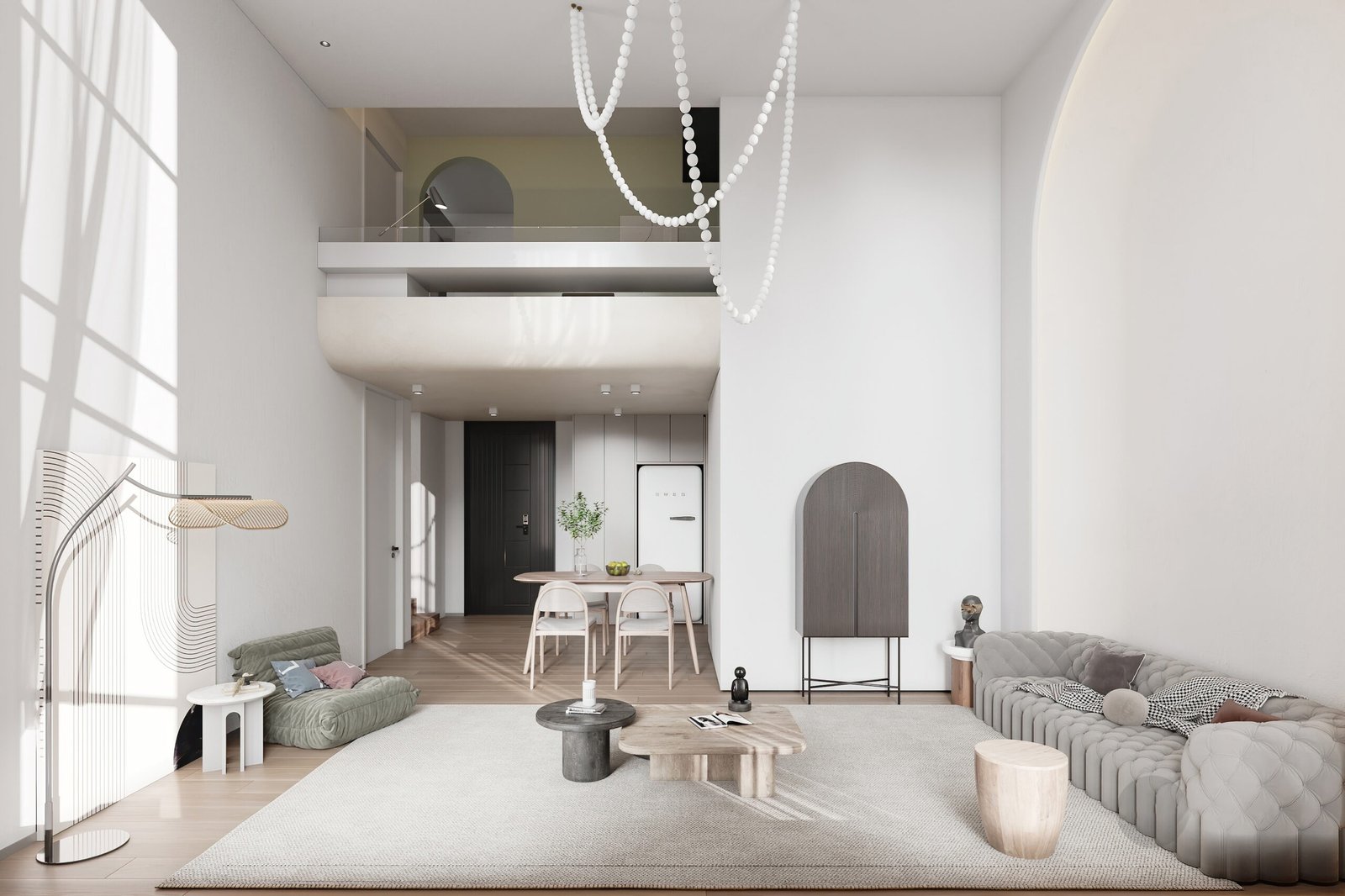 A bright double-height minimalist living room with grey tufted sofa, green floor sofa, organic coffee tables, and a white bead chandelier