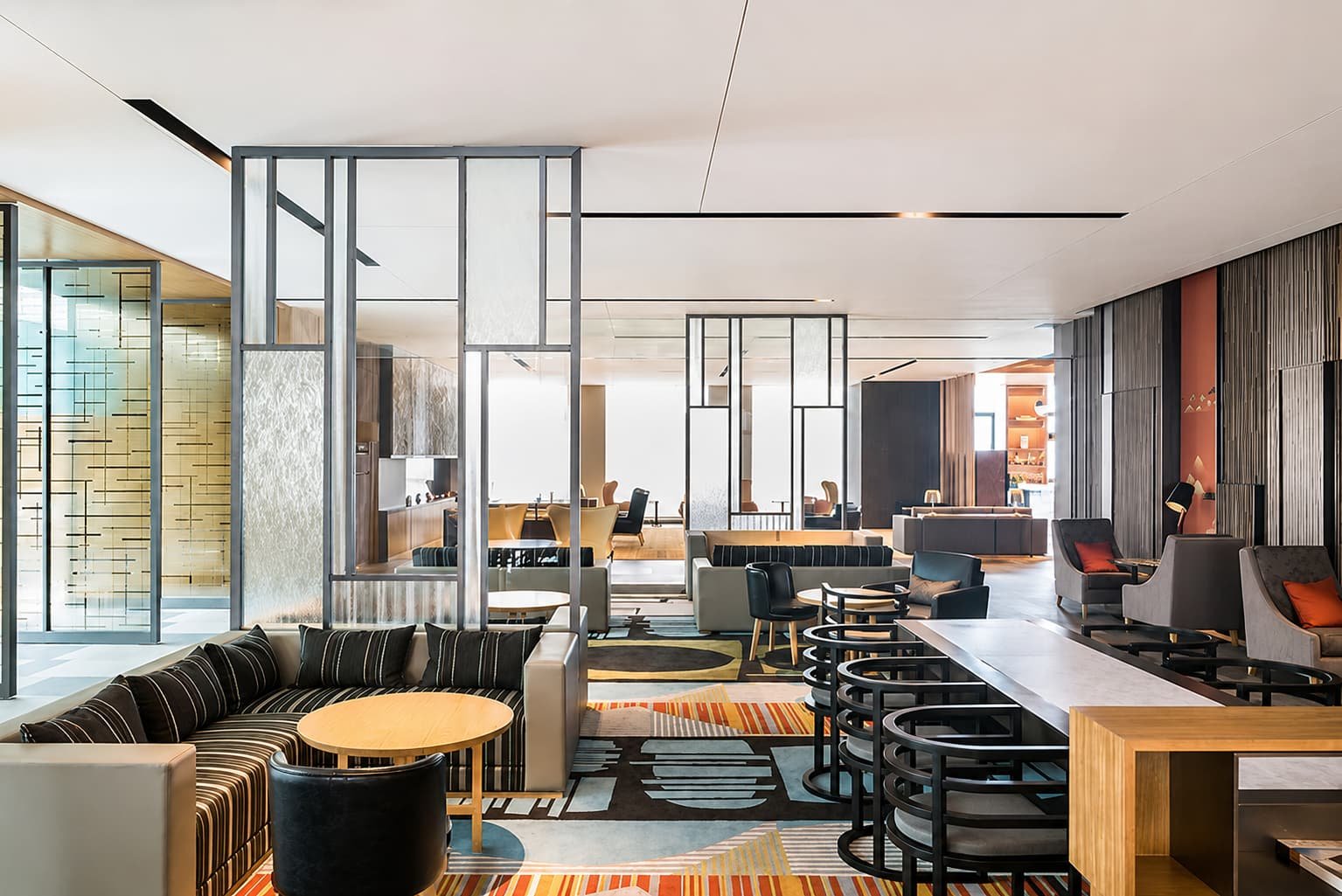 Modern lounge and lobby interior at Hyatt Regency Luoyang, Henan, featuring contemporary sofas, armchairs, side tables, and other coordinated furniture arranged throughout the spacious open layout.