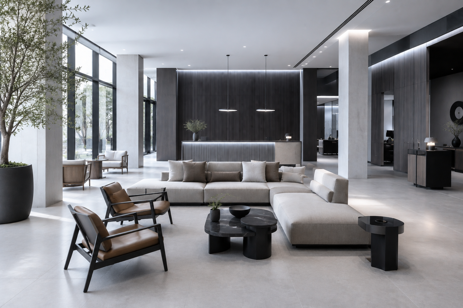 Modern hotel lobby with minimalist luxury furniture, including a large cream sectional sofa, leather lounge chairs, and black sculptural coffee tables, illuminated by soft bluish-white indoor lighting and natural afternoon light.