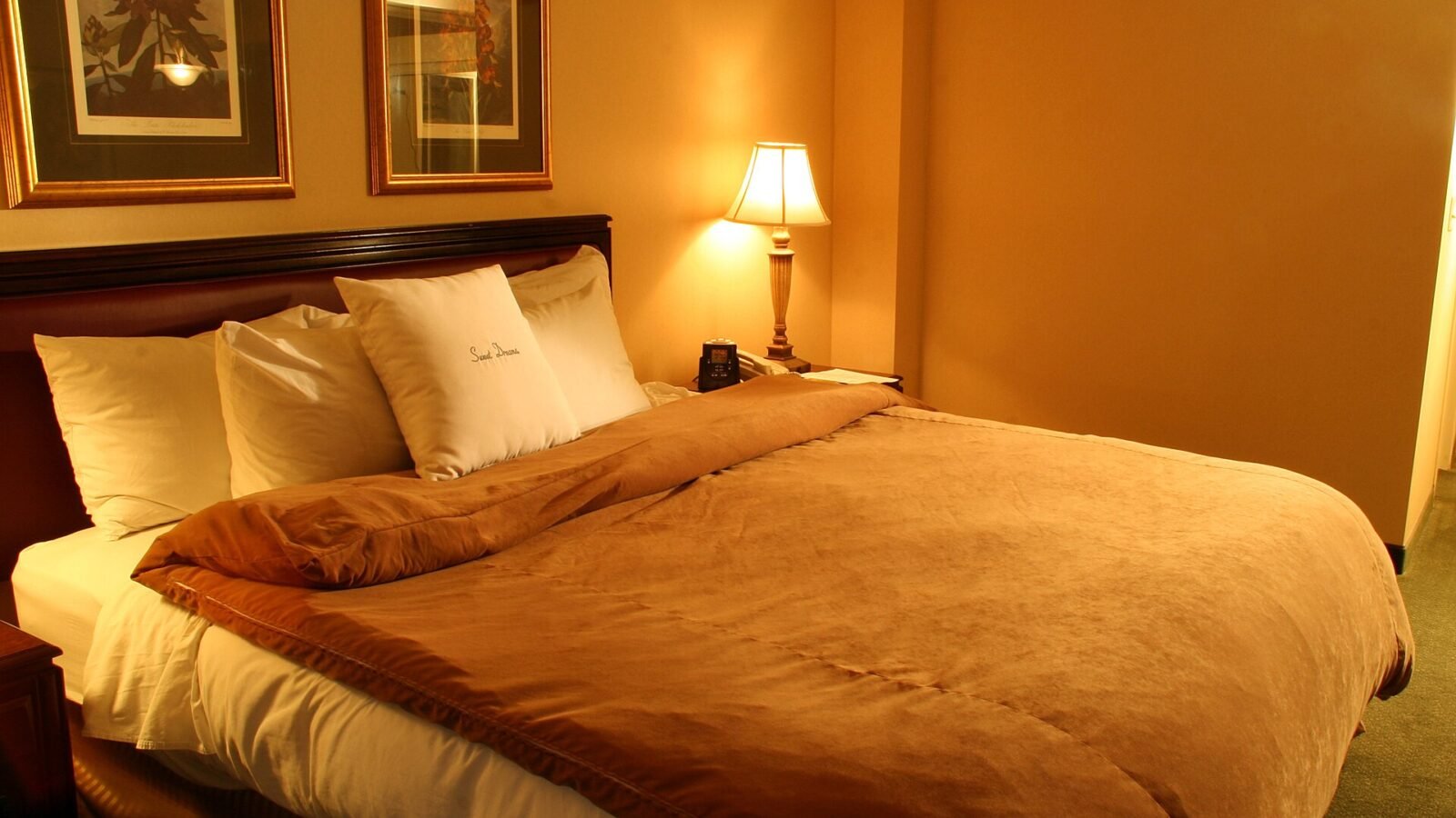 Hotel suite bedroom with bed and furnishings, featured image